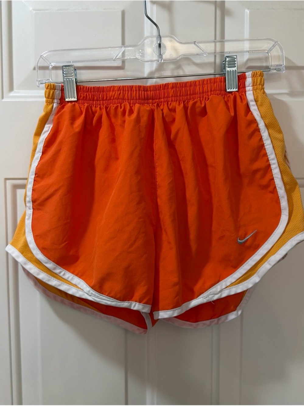 Nike Dri Fit orange/yellow running shorts with white trim, size medium